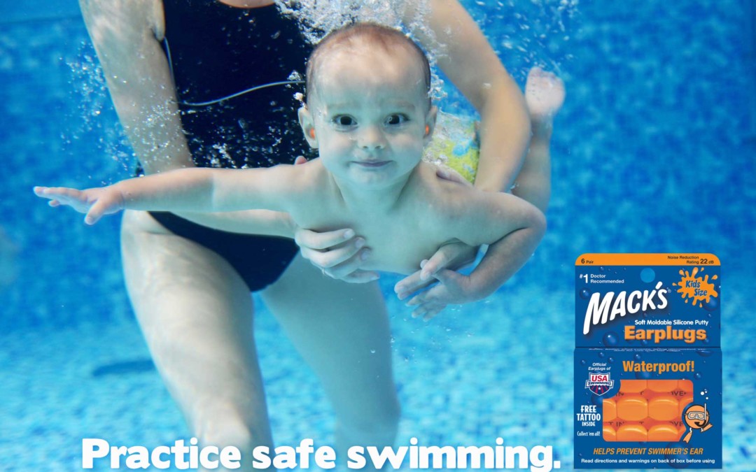 a toddler swimming underwater wearing Mack's Kid's Earplugs