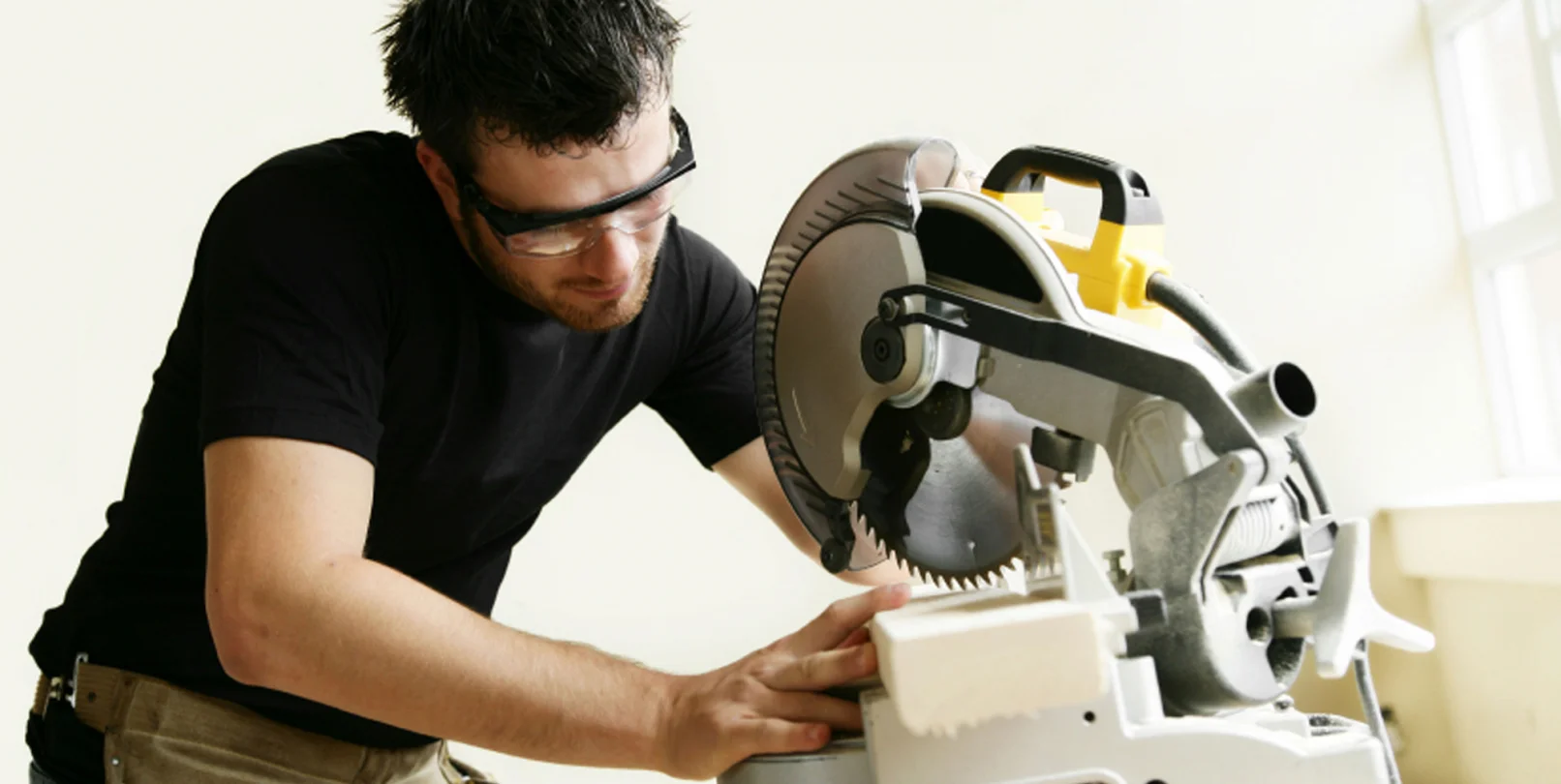 a man in a workshop wearing Mack's ultra soft foam ear plugs